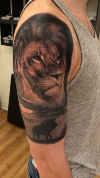 Black And Grey Lion Tattoo