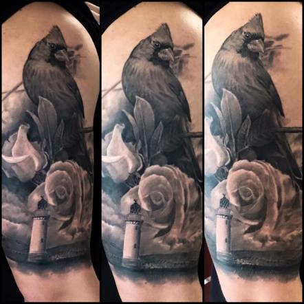 Black and Grey Cardinal Portrait with Photo Realistic Rose and Lighthouse Scene Tattoo
