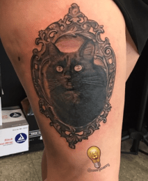 Black and Grey Cat Portrait with Filigree Frame Tattoo