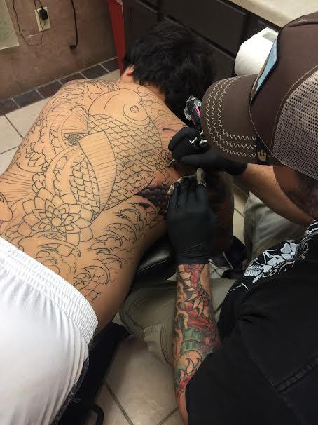 Chad working hard on this giant Koi back piece
