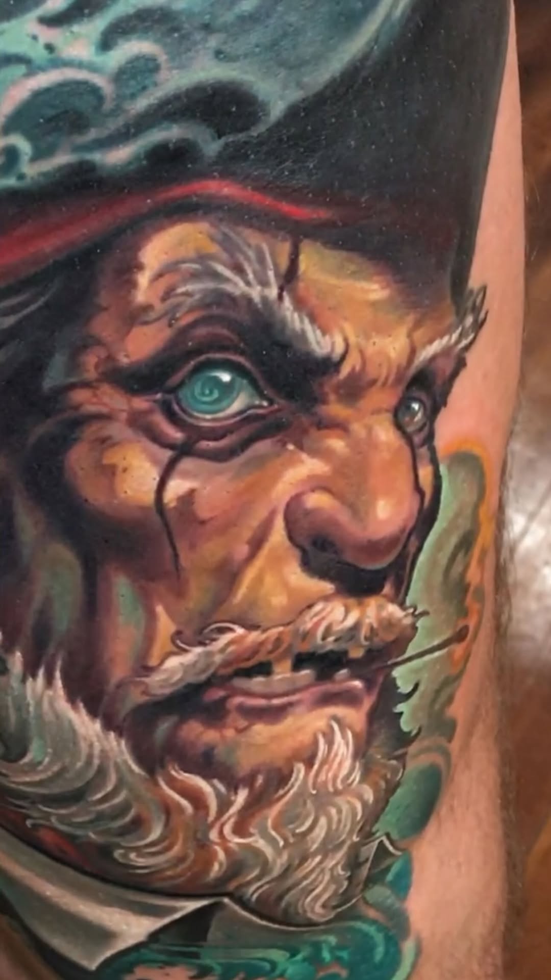 Color fantasy portrait tattoo with ornamental details, arm