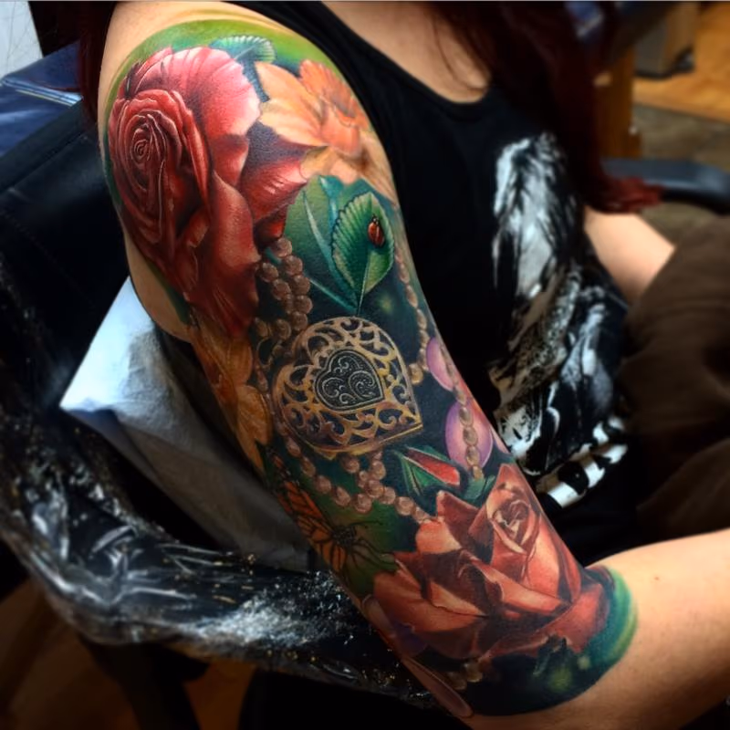 Realistic roses with locket and lady bug color tattoo, Brent Olson Art Junkies Tattoo