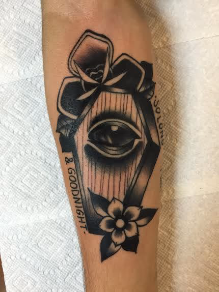 Traditional black coffin with eye and flowers tattoo. Frichard Adams Art Junkies Tattoo