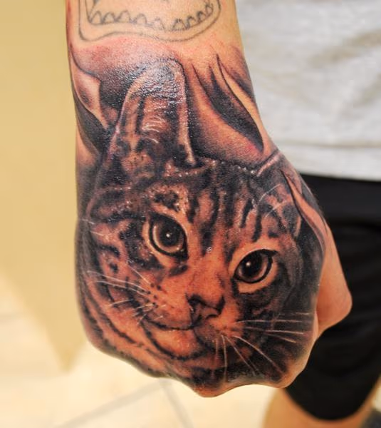 Muecke Cat Hand Tattoo