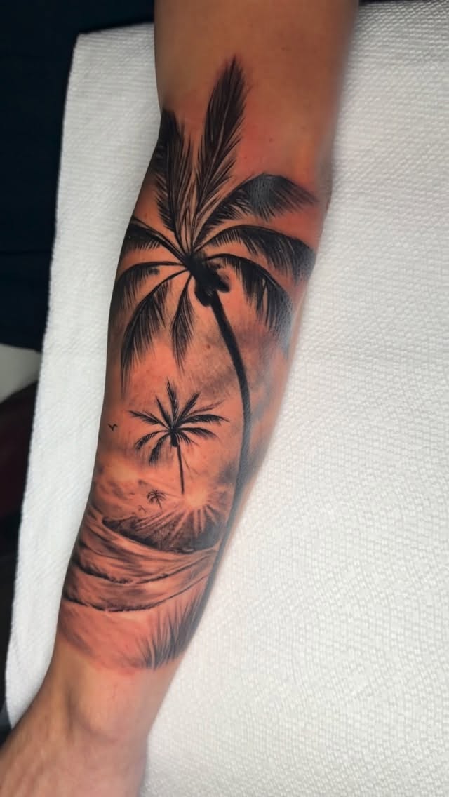 Black-and-grey palm tree beach scene, forearm