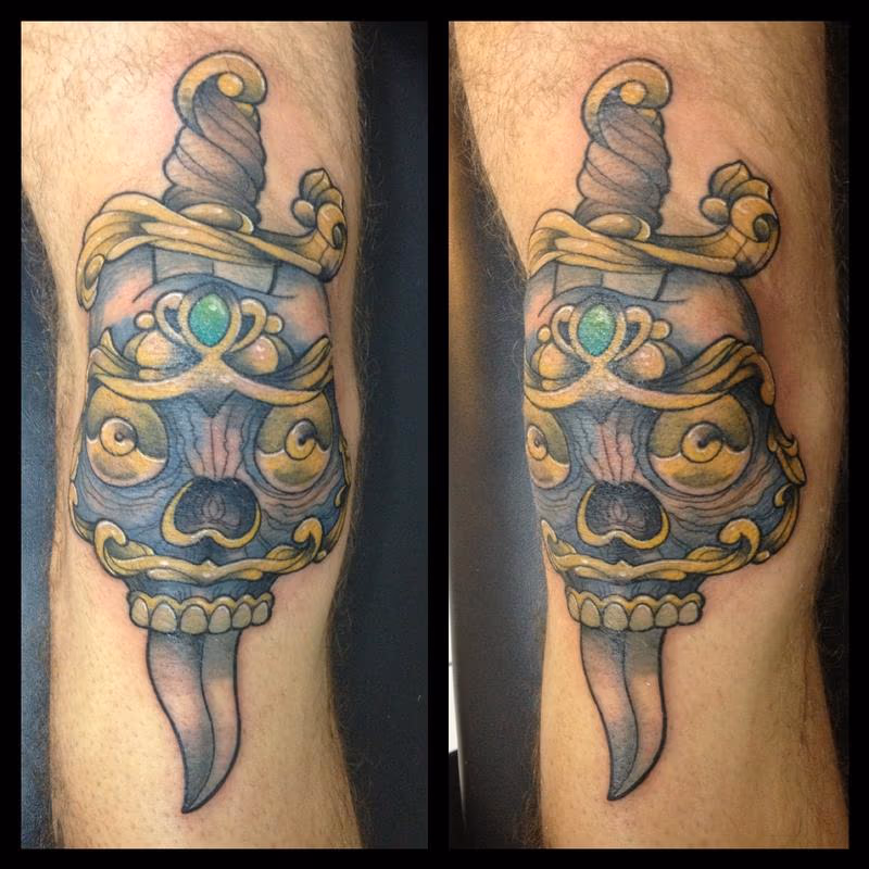 skull and dagger on a knee