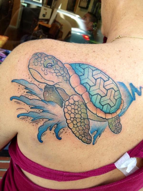 Sea turtle surfing on a wave