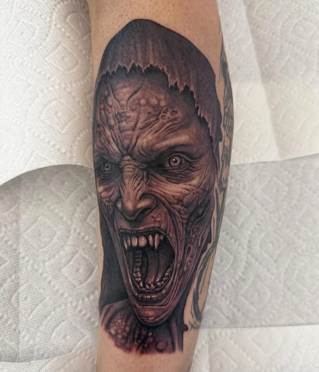 Demonic creature portrait, calf tattoo