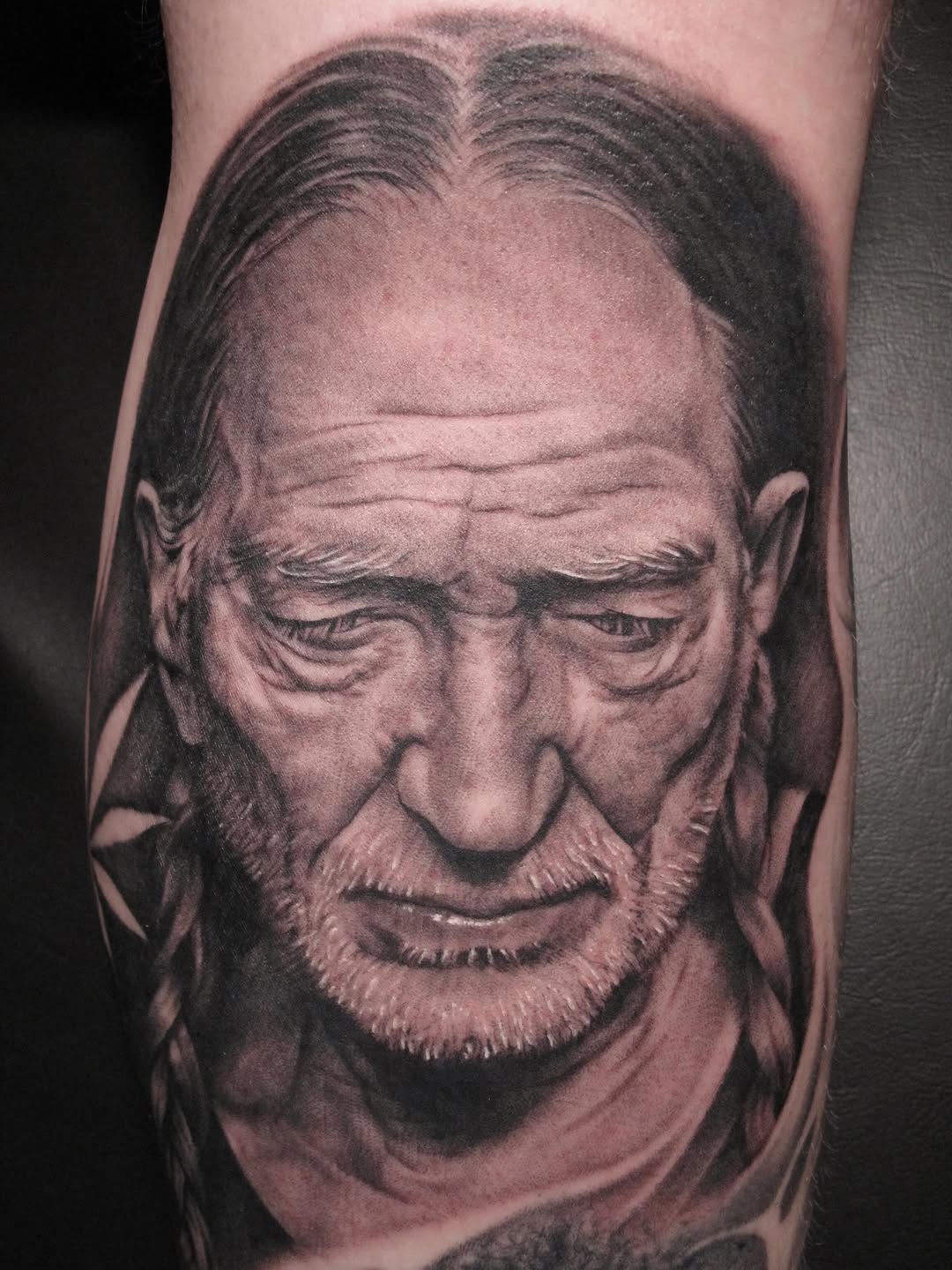 Willie Nelson portrait tattoo, thigh