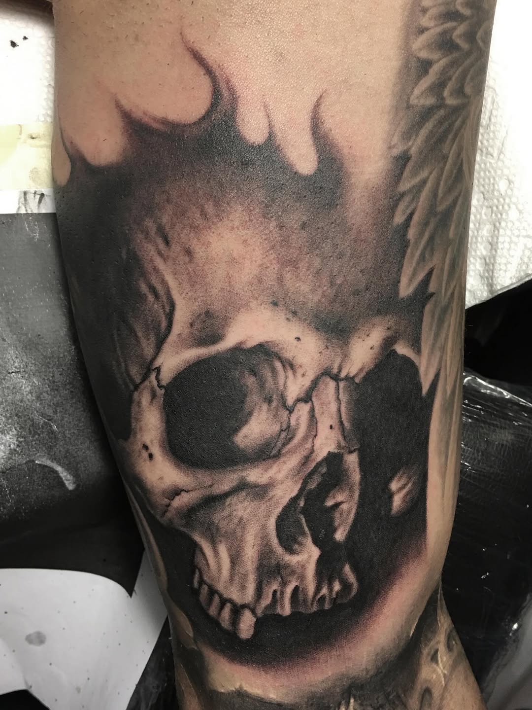 Black-and-grey skull portrait on arm