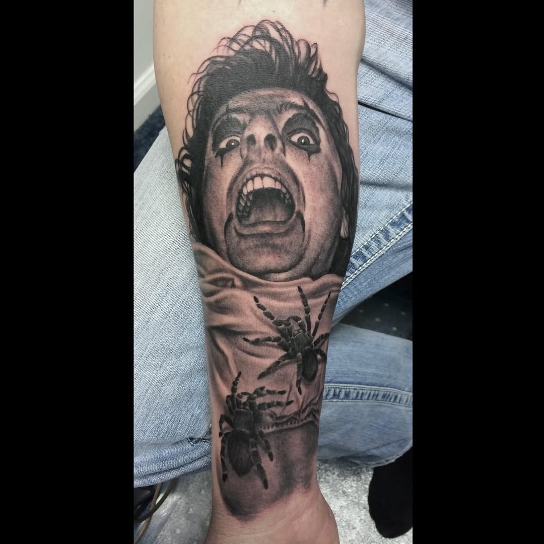 Alice Cooper portrait tattoo with spiders, forearm