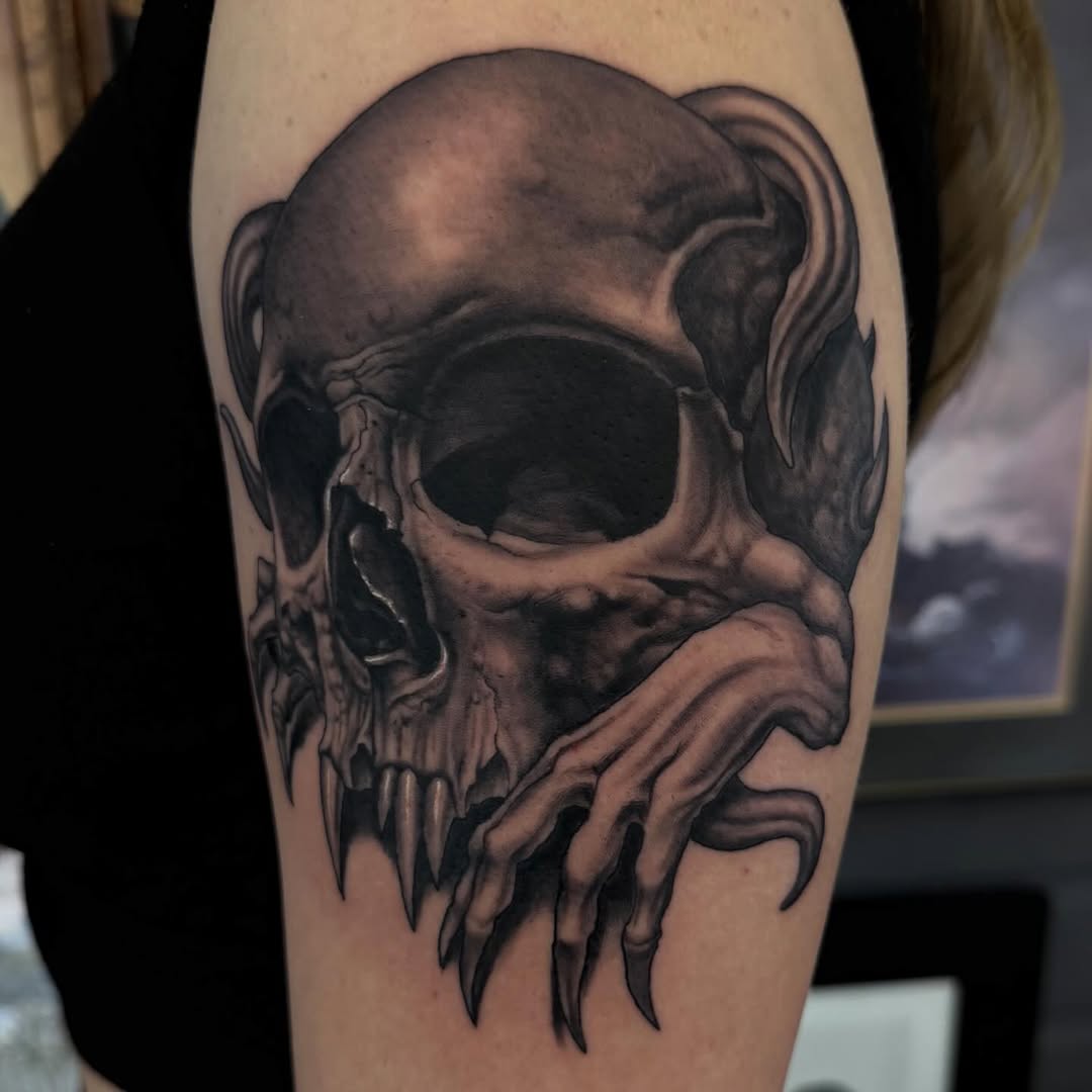 Black-and-grey skull with dripping effect, arm