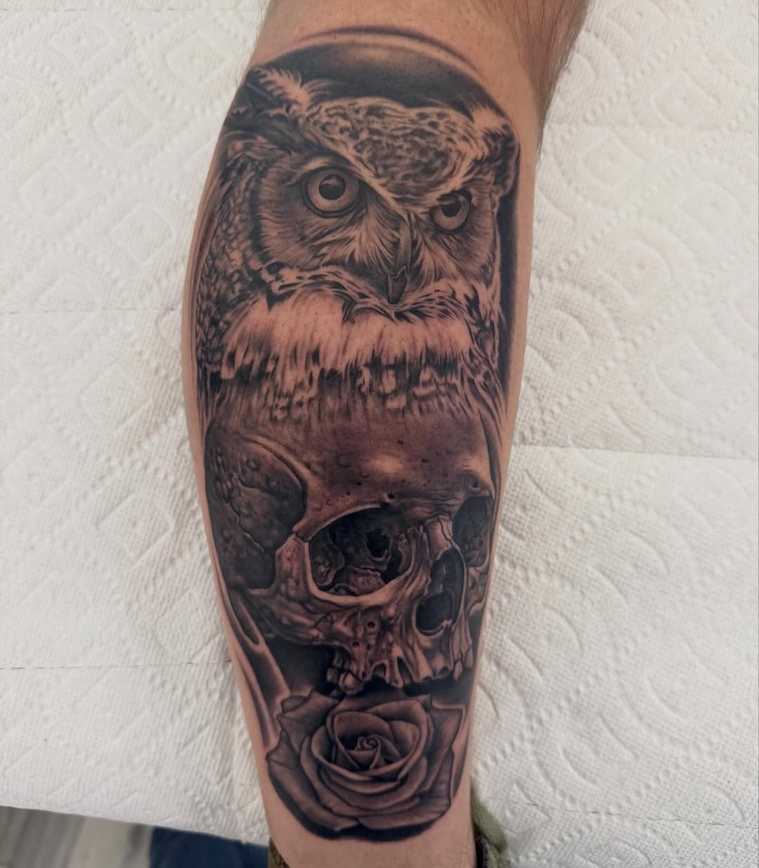 Black-and-grey owl skull rose leg tattoo
