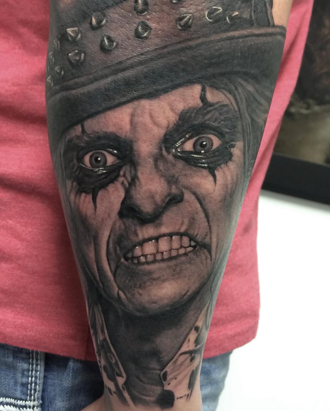 Alice Cooper portrait with studded crown, forearm