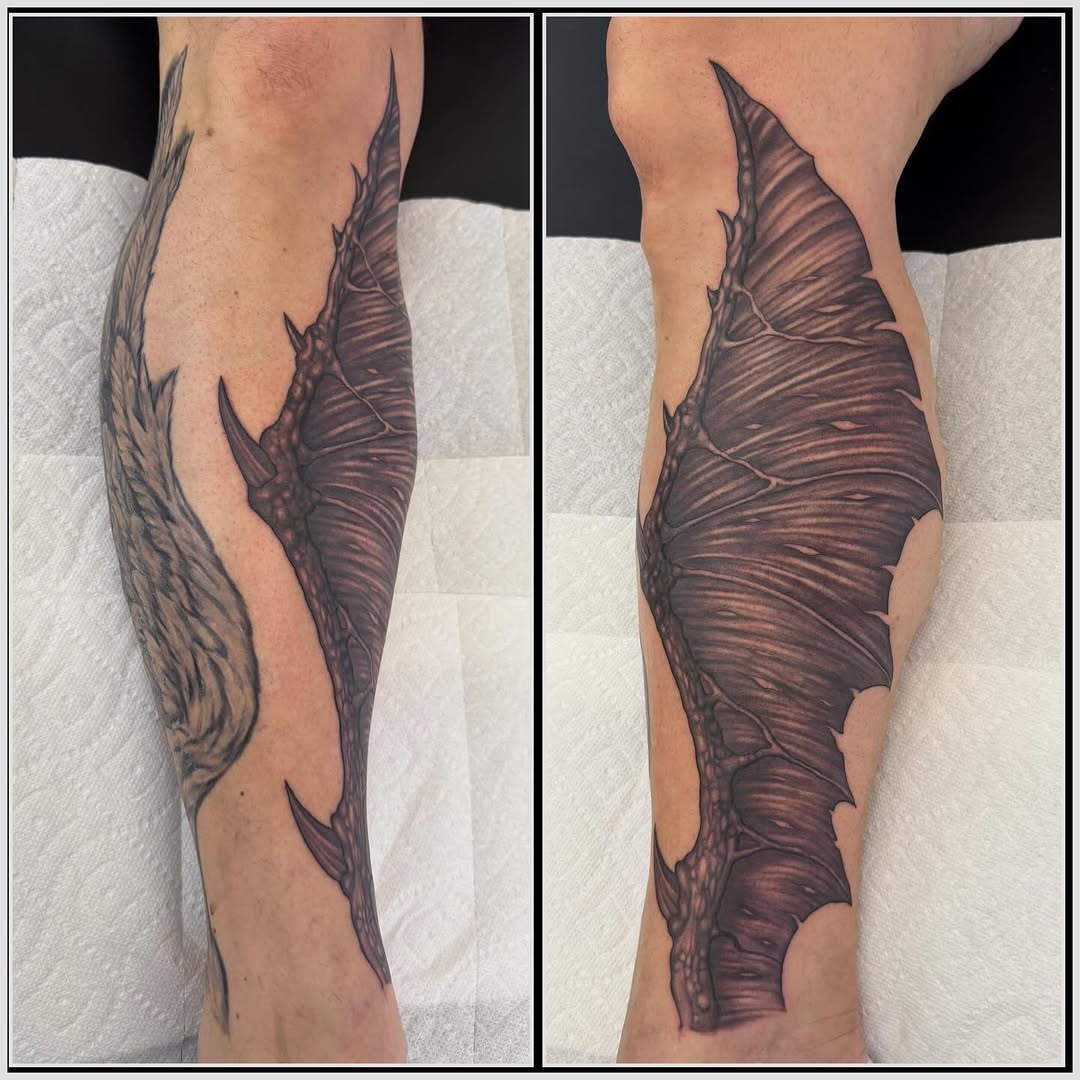 Demon wing calf tattoo in black and grey