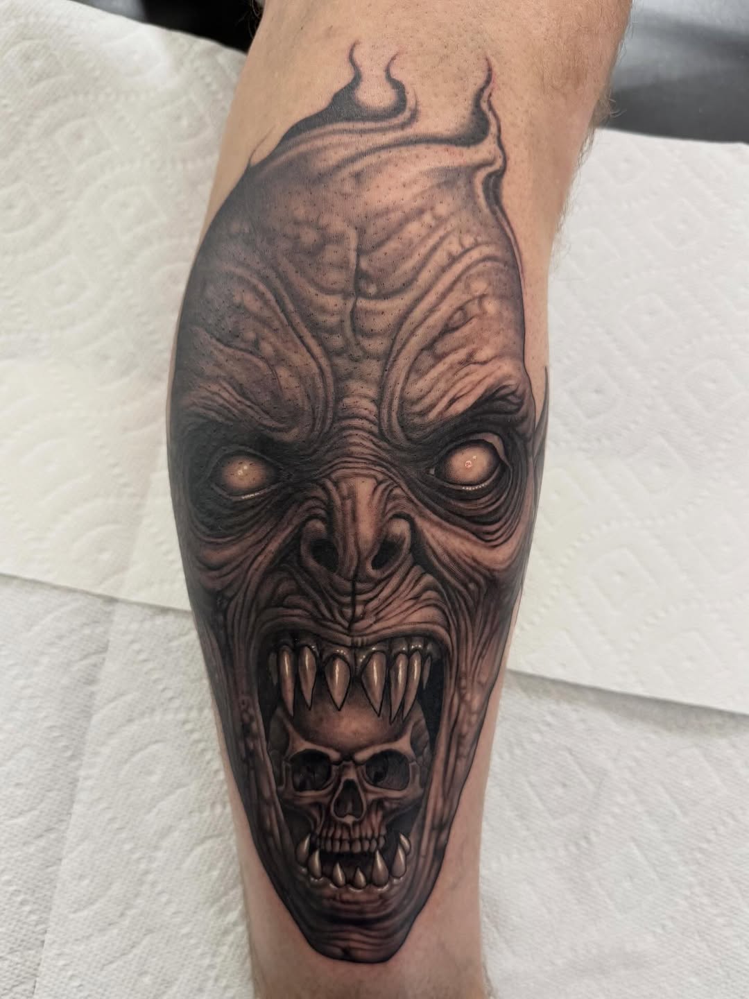 Demonic skull and horned face, black-and-grey calf