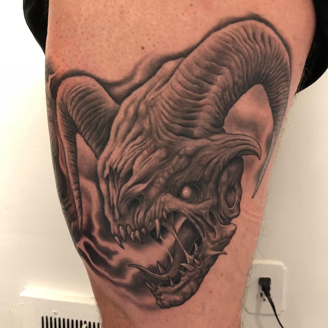 Black-and-grey monster portrait, thigh