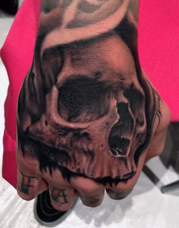 Skull hand tattoo