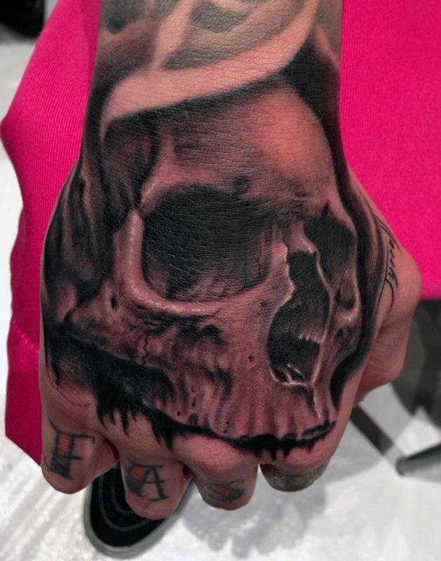 Skull hand tattoo