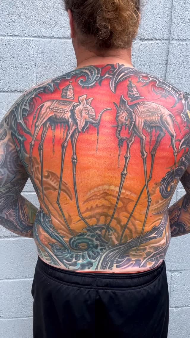 Biomechanical back piece with elongated creatures