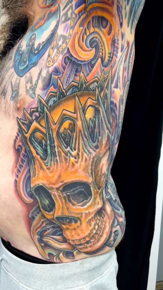 Biomechanical skull rib and side tattoo
