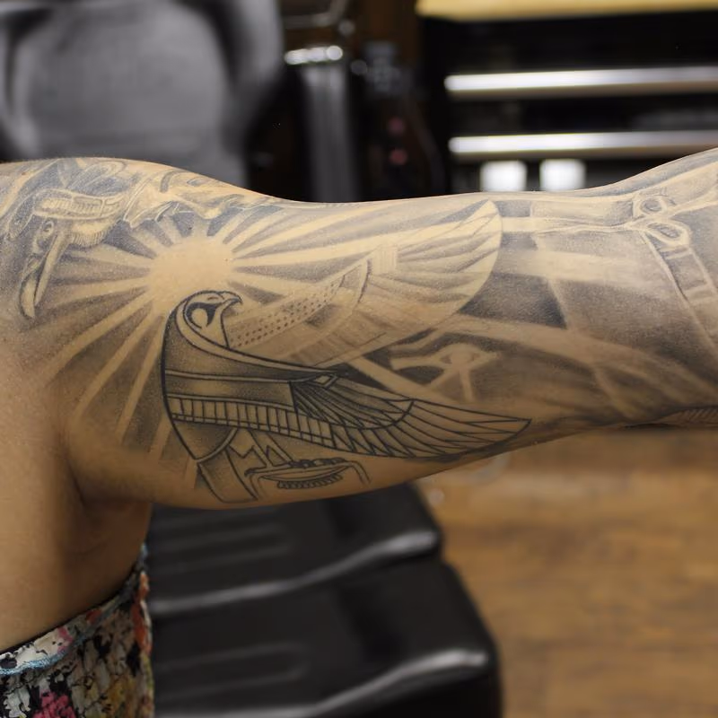 Egyptian bird Horus connecting to a pharaoh and Egyptian queen Nefertiti on the inside of a sleeve.
