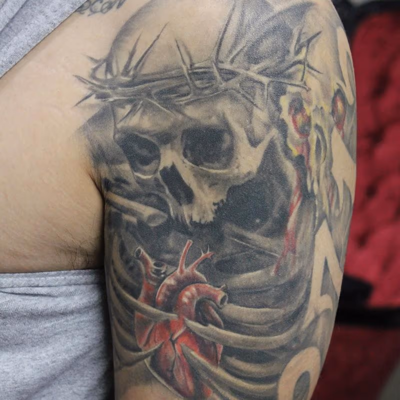 Healed Black and Grey Skull and Rib Cage Sleeve with a realistic color heart