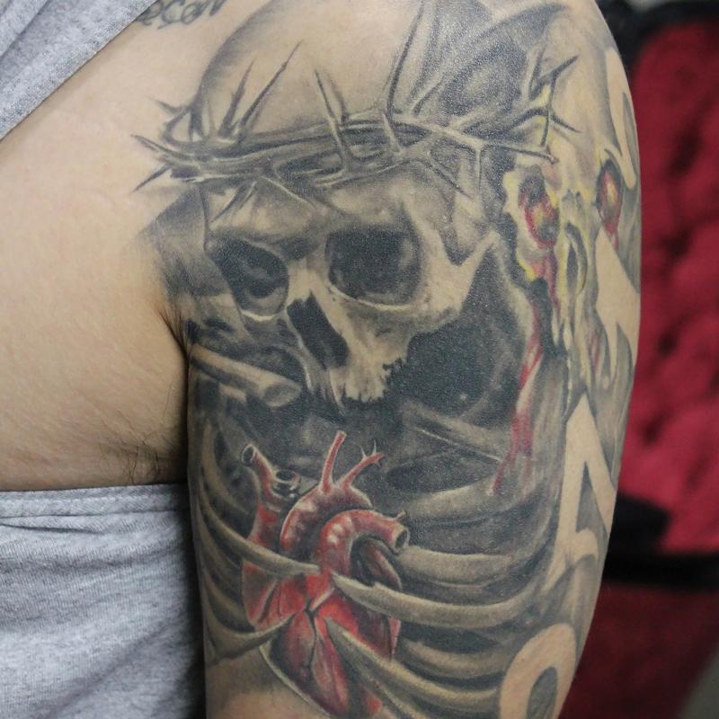 Healed Black and Grey Skull and Rib Cage Sleeve with a realistic color heart