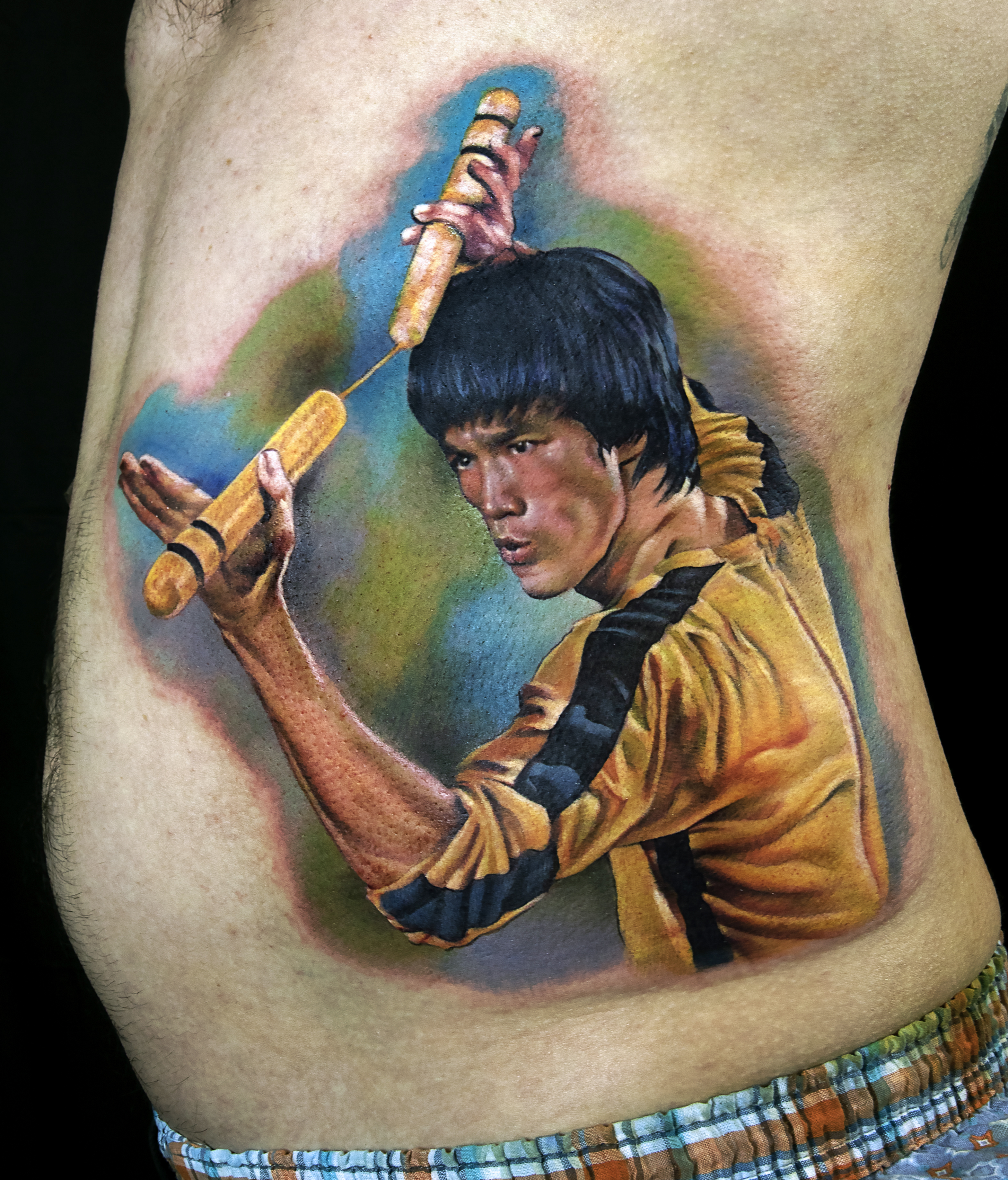 Bruce Lee color portrait tattoo