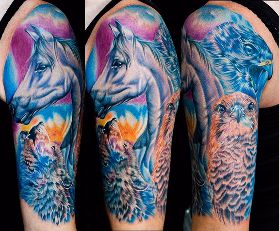 this tattoo has a portrait of her horse which represents her heart falcons for her freedom and a wolf for her sprit she let me have total control of design and color really fun piece done with stigma hyper and fusion ink