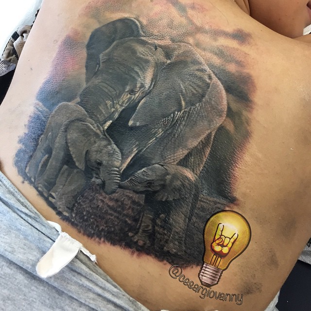 Realistic elephant family back tattoo, black-and-grey