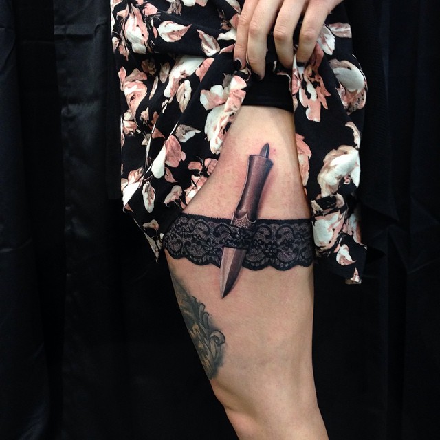 Black-and-grey dagger and lace garter, thigh