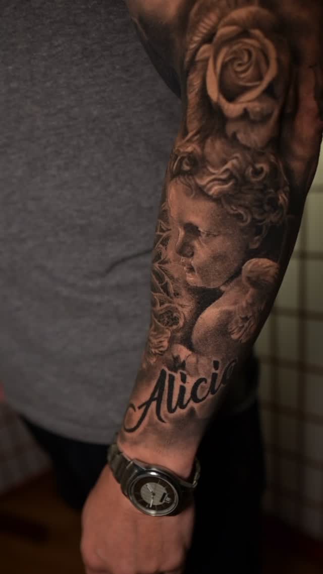 Black-and-grey cherub and rose sleeve with script