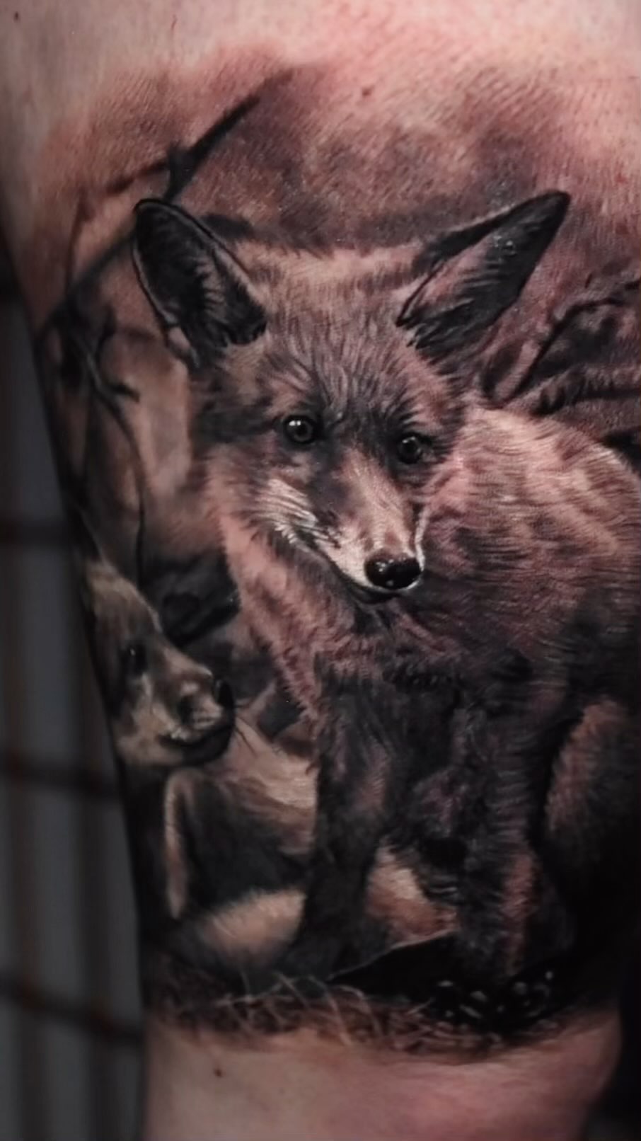 Black-and-grey fox portrait tattoo