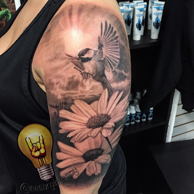 Black-and-grey bird and daisies, bicep