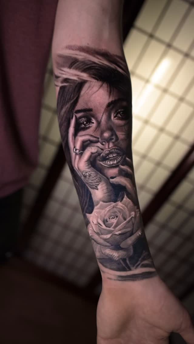Black-and-grey woman portrait with rose, forearm
