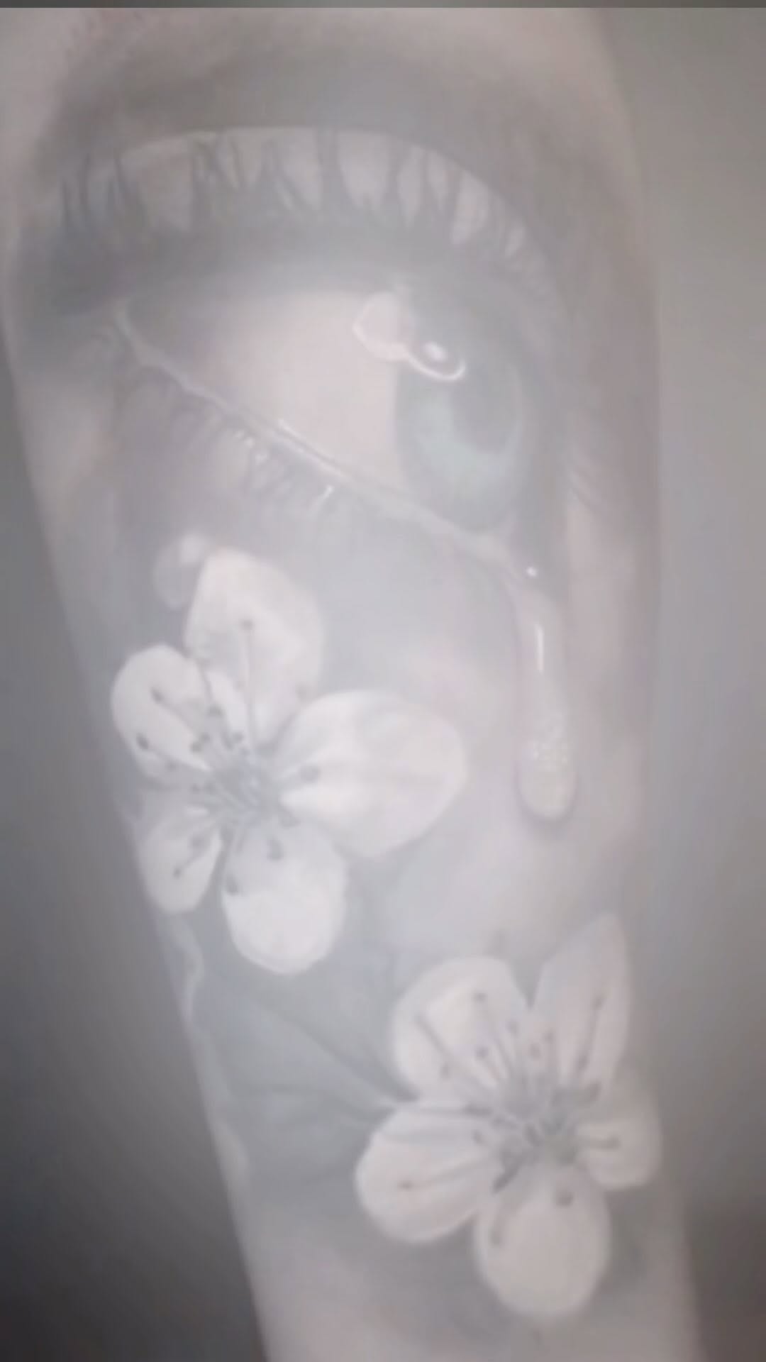 Realistic eye and cherry blossoms, black-and-grey