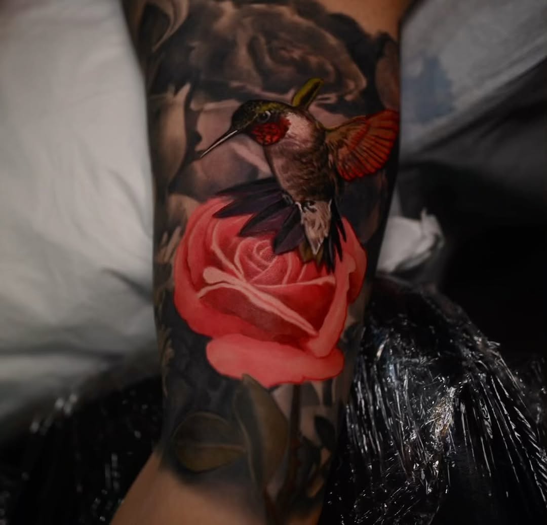 Realistic hummingbird and red rose forearm tattoo