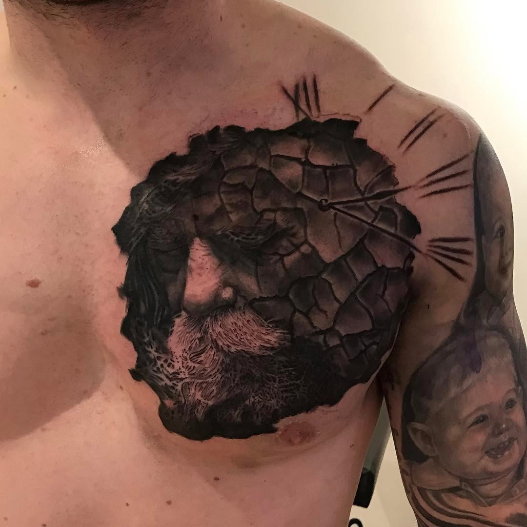 Black-and-grey bearded man & clock chest tattoo