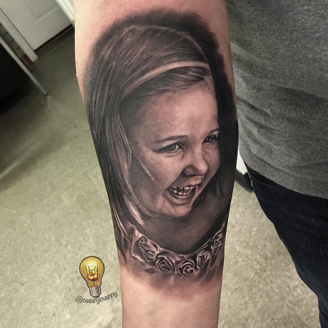 Black-and-grey portrait of a young girl, forearm