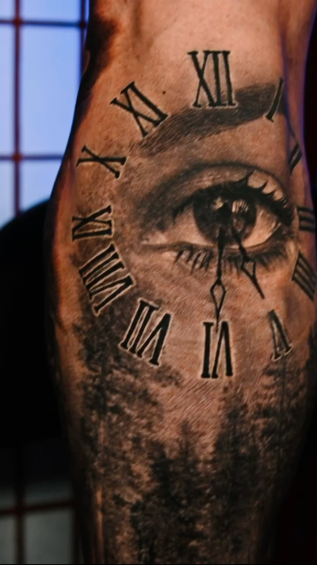 Realistic eye and Roman numeral clock tattoo