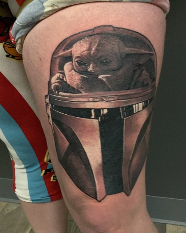 Baby Yoda in Mandalorian helmet, thigh tattoo