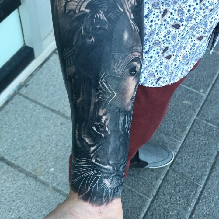 Black-and-grey lion and warrior woman sleeve