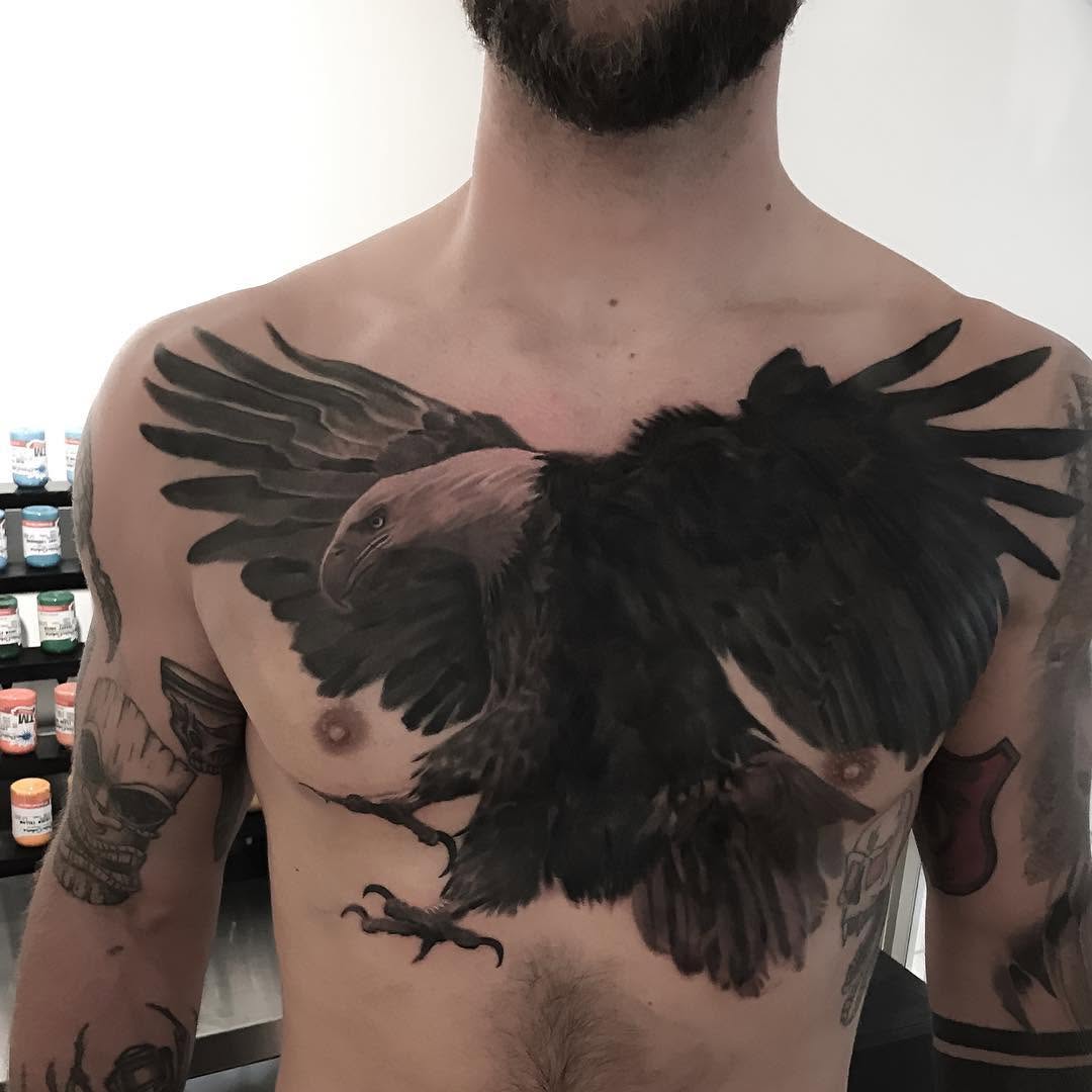 Black-and-grey bald eagle chest tattoo
