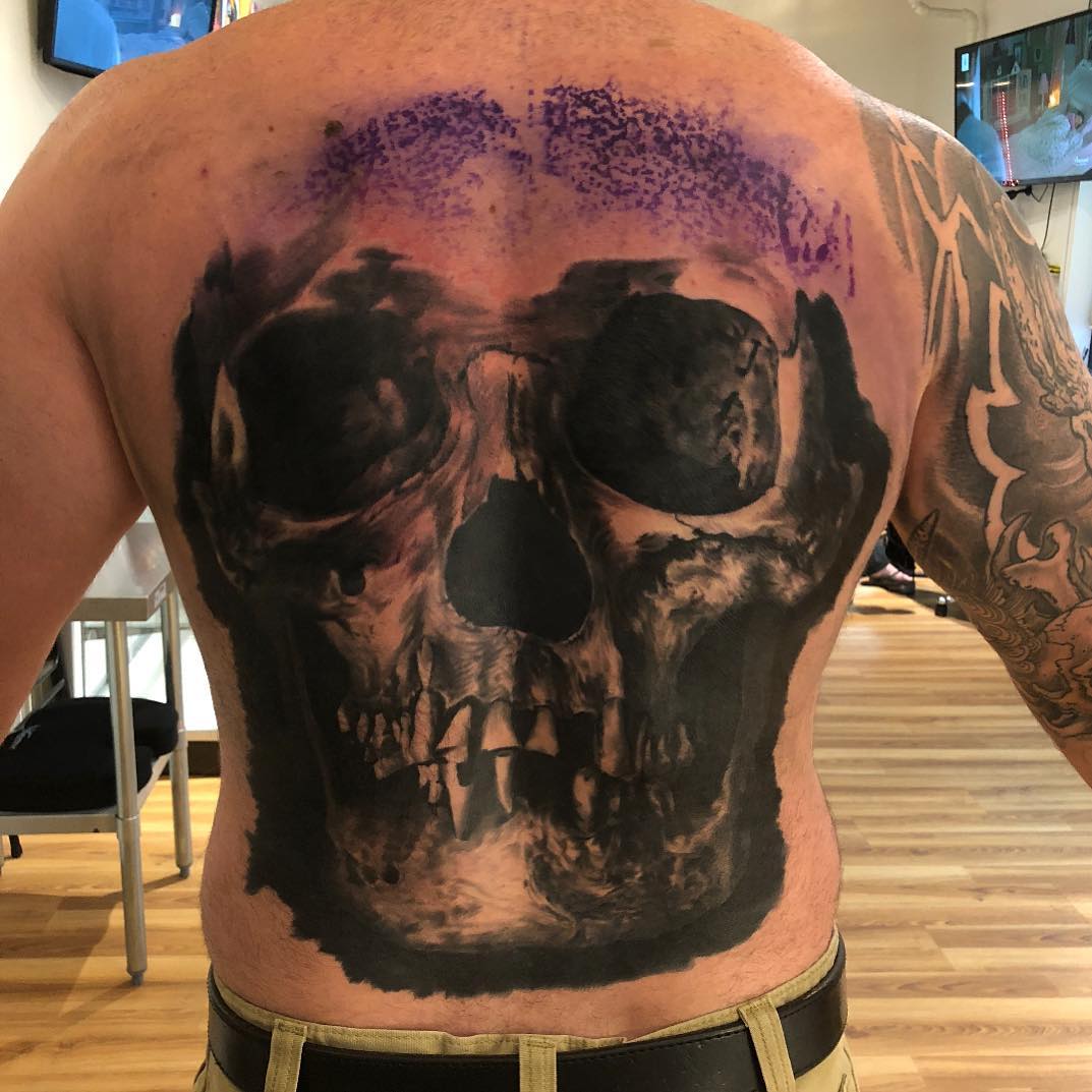 Realistic skull back piece in black and grey