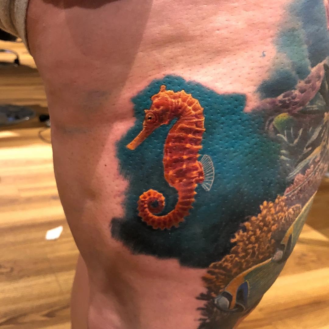 Realistic seahorse tattoo in color, thigh