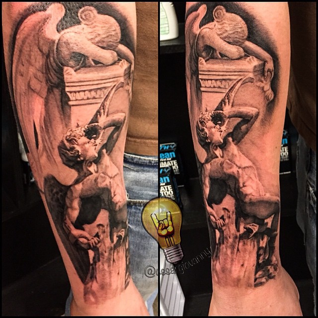 Black-and-grey angel & Atlas statue forearm tattoo