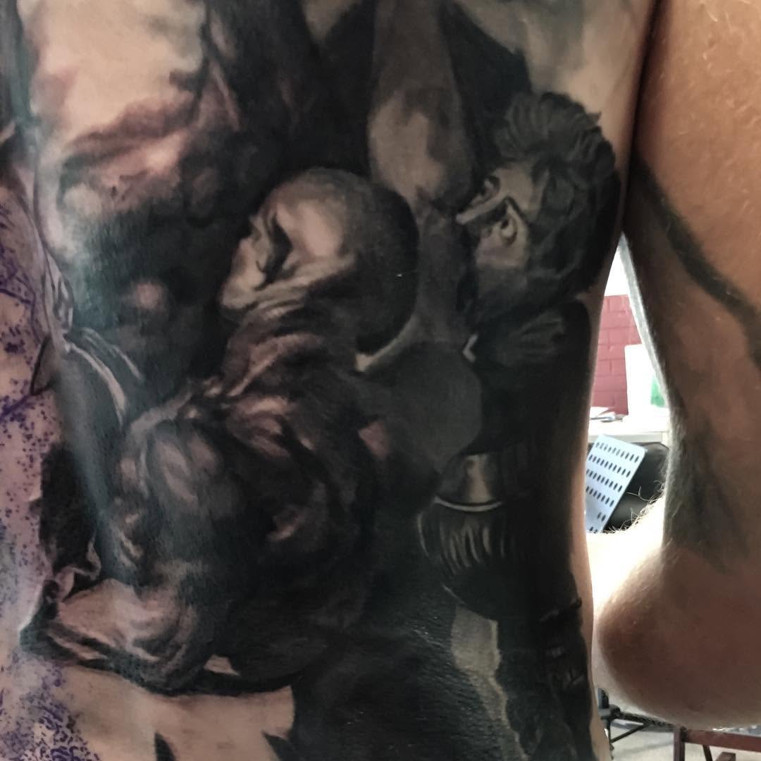 Black-and-grey religious back piece in progress
