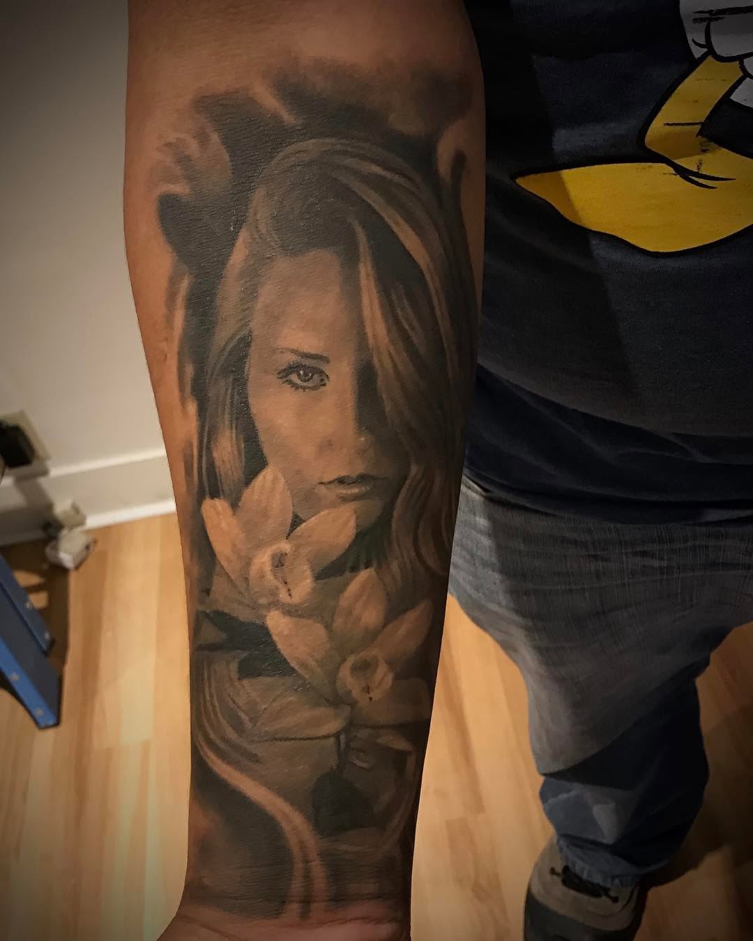 Black-and-grey portrait with orchids, forearm
