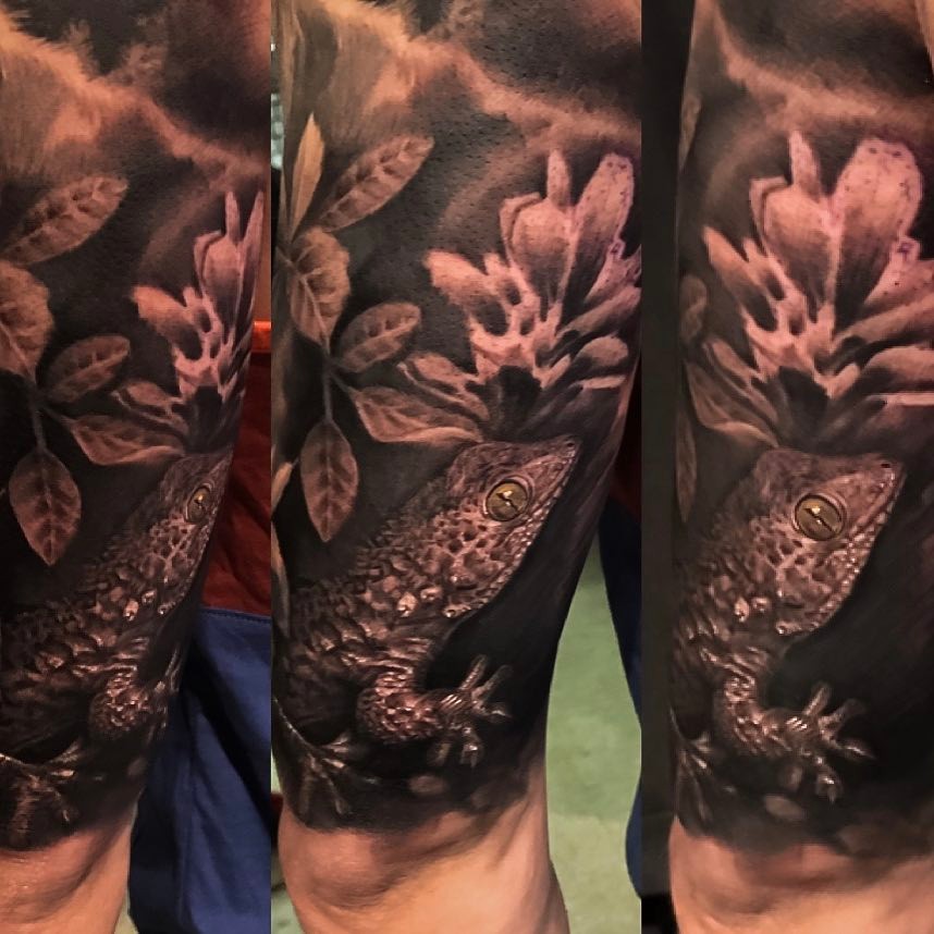 Black-and-grey gecko and floral tattoo, leg